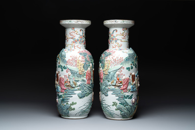 A pair of Chinese famille rose '18 luohan' vases with relief design, 19th C.