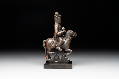 A rare Chinese bronze Vaishravana on horseback with wooden stand, Yuan