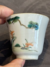 A pair of Chinese famille rose 'monkey and deer' cups and saucers, Tongzhi mark and of the period