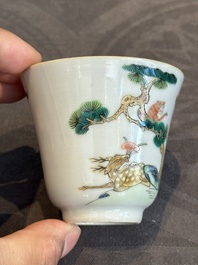A pair of Chinese famille rose 'monkey and deer' cups and saucers, Tongzhi mark and of the period