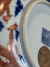 An imperial Chinese blue, white and iron-red 'dragon' plate, Qianlong mark and of the period