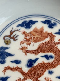 An imperial Chinese blue, white and iron-red 'dragon' plate, Qianlong mark and of the period