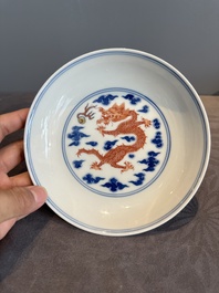 An imperial Chinese blue, white and iron-red 'dragon' plate, Qianlong mark and of the period