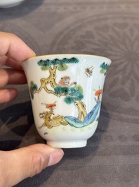 A pair of Chinese famille rose 'monkey and deer' cups and saucers, Tongzhi mark and of the period