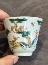 A pair of Chinese famille rose 'monkey and deer' cups and saucers, Tongzhi mark and of the period