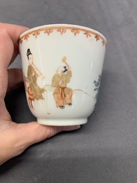 A Chinese famille rose cup and saucer with a lady playing flute, a boy and a phoenix, Qianlong