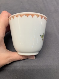 A Chinese famille rose cup and saucer with a lady playing flute, a boy and a phoenix, Qianlong