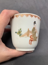 A Chinese famille rose cup and saucer with a lady playing flute, a boy and a phoenix, Qianlong