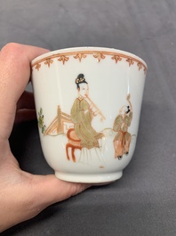 A Chinese famille rose cup and saucer with a lady playing flute, a boy and a phoenix, Qianlong