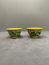 A pair of Chinese yellow-ground 'dragon' and 'shou' bowls, Guangxu mark and of the period