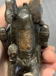 A rare Chinese bronze Vaishravana on horseback with wooden stand, Yuan