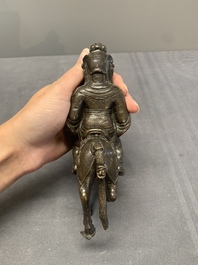 A rare Chinese bronze Vaishravana on horseback with wooden stand, Yuan