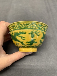 A pair of Chinese yellow-ground 'dragon' and 'shou' bowls, Guangxu mark and of the period