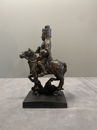 A rare Chinese bronze Vaishravana on horseback with wooden stand, Yuan