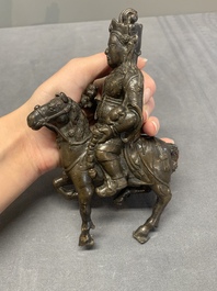 A rare Chinese bronze Vaishravana on horseback with wooden stand, Yuan