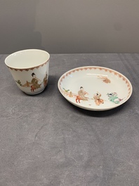 A Chinese famille rose cup and saucer with a lady playing flute, a boy and a phoenix, Qianlong