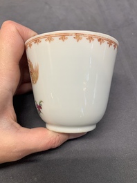 A Chinese famille rose cup and saucer with a lady playing flute, a boy and a phoenix, Qianlong
