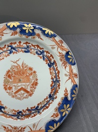Two Chinese famille rose plates and an Imari-style armorial plate, Kangxi/Yongzheng