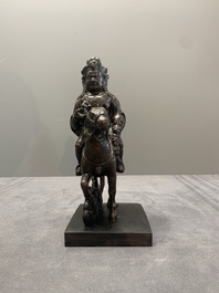 A rare Chinese bronze Vaishravana on horseback with wooden stand, Yuan