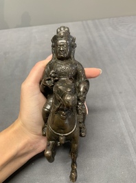 A rare Chinese bronze Vaishravana on horseback with wooden stand, Yuan