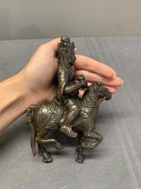 A rare Chinese bronze Vaishravana on horseback with wooden stand, Yuan