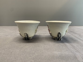 A pair of Chinese Dehua blanc de Chine relief-decorated famille rose 'prunus' cups, 19th C.