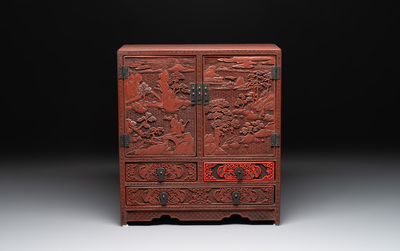 A Chinese cinnabar lacquer 'mountainous landscape' cabinet, 19th C.