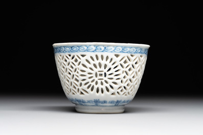 A Chinese blue and white reticulated double-walled cup and saucer, lingzhi mark, Kangxi