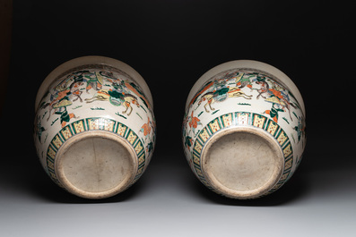 A pair of Chinese Nanking famille verte 'warriors' fish bowls, 19th C.