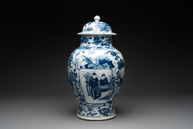 A pair of Chinese blue and white vases and covers with figural panels, 19th C.