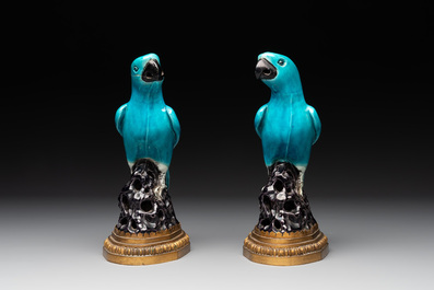 A pair of turquoise- and aubergine-glazed parrots with gilt bronze mounts, Kangxi