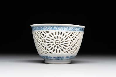 A Chinese blue and white reticulated double-walled cup and saucer, lingzhi mark, Kangxi