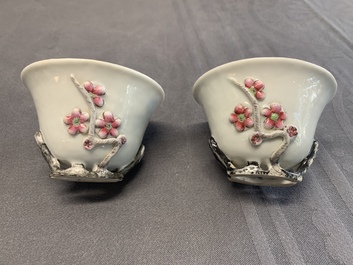 A pair of Chinese Dehua blanc de Chine relief-decorated famille rose 'prunus' cups, 19th C.