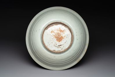 A rare Chinese Swatow slip-decorated pale-green-glazed 'dragon' dish, Ming