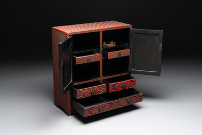 A Chinese cinnabar lacquer 'mountainous landscape' cabinet, 19th C.