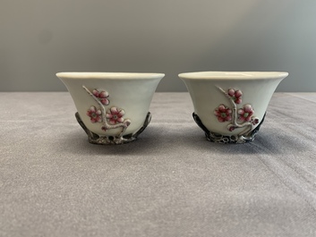 A pair of Chinese Dehua blanc de Chine relief-decorated famille rose 'prunus' cups, 19th C.