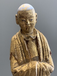 A Chinese gilt and polychromed stucco figure of a monk, Ming