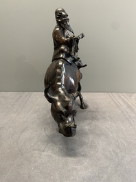 A Chinese gold-splashed bronze incense burner in the shape of an immortal riding a buffalo, 19th C.