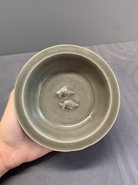A Chinese Longquan celadon 'twin fish' dish and two 'twin fish' saucers, Yuan/Ming