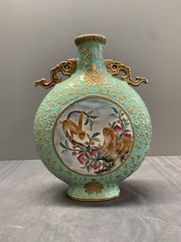 A Chinese gilt-decorated famille rose turquoise 'monkeys' and 'dogs' moon flask, Qianlong mark, 20th C.