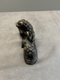 A rare Chinese bronze 'three dancing lions' paperweight or brush rest, Ming