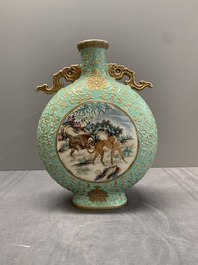 A Chinese gilt-decorated famille rose turquoise 'monkeys' and 'dogs' moon flask, Qianlong mark, 20th C.