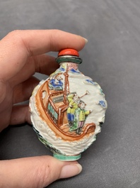 A Chinese famille rose relief-molded snuff bottle with narrative design, Xianfeng mark and of the period