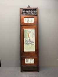 A Chinese carved wooden panel with famille rose Wang Qi 王琦-style plaques, dated 1932