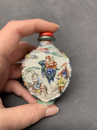 A Chinese famille rose relief-molded snuff bottle with narrative design, Xianfeng mark and of the period