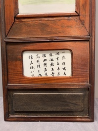 A Chinese carved wooden panel with famille rose Wang Qi 王琦-style plaques, dated 1932