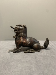 A rare Chinese bronze lion-form incense burner and cover, Song/Ming