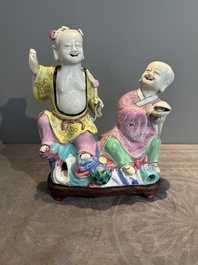 A Chinese famille rose group of Hehe Erxian on wooden stand, Qianlong