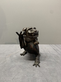 A rare Chinese bronze lion-form incense burner and cover, Song/Ming