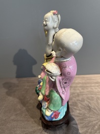 A Chinese famille rose group of Hehe Erxian on wooden stand, Qianlong